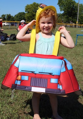 Three-year-old Lauren Cromwell of Port Dover gets ready to ride on Saturday at the Norfolk County Annual Pump Comp in Courtland.  Teams of local volunteer firefighters battle it out in the fun competition, this year hosted by the Courtland Firefighters.  Michelle Ruby