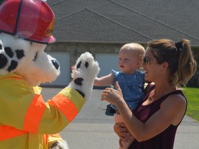 TOUCHING MOMENT
Sparky the Fire Prevention Dog and Evelyn LaSalle share a moment as her mom Dana Yates looks on at the second annual Touch a Truck event at MERC Hall in Maitland on Saturday afternoon.
Tim Ruhnke/Postmedia Network