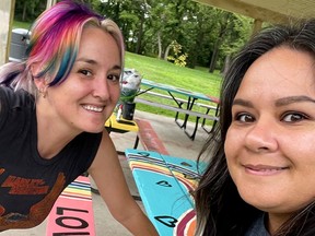 Sarah Steele, left, and Morena McDonald are seen here after transforming a picnic table McDonald had originally painted a rainbow on, but was vandalized. Their redesign include the words "Love Wins." Other painted picnic tables were recently vandalized in the community that police are investigating as a hate-motivated incident due to the derogatory messages, including violence, towards the 2S LGBTQ+ community. (Contributed photo)