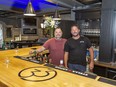 Jordan Gawley (left) and Darcy Fournier stand behind the bar in Lounge 33, set to open in August as part of the Capitol 33 entertainment venue in downtown Delhi, Ontario.