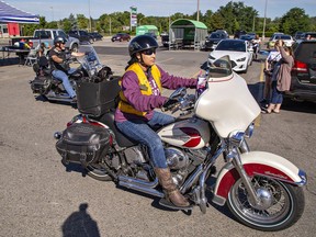 Tereca Ford of Brantford heads out on the Ride to Thrive charity motorcycle run with her long-haired chihuahua Benita on board on Saturday.