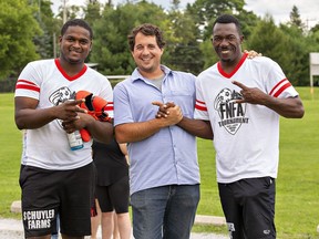 Brett Schuyler, owner of Schuyler Farms, is joined by two of his employees Randell Richards (left) and Cemore Gordon at the annual Farms of Norfolk Football Association tournament on Sunday in Simcoe.