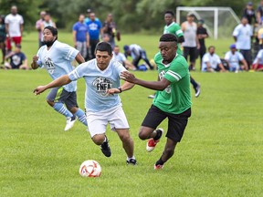 The players of the Winkelmolen Nursery Ltd.  (left) and EZ Grow Farms battle for the ball during the annual Farms of Norfolk Football Association tournament on Sunday in Simcoe.