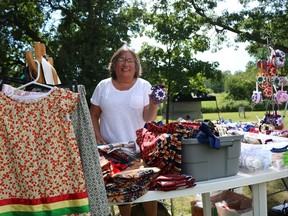 Mamie David holding one of her hand-made ornaments at her booth on Akwesasne Friendship Day on Sunday August 7, 2022 in Akwesasne, Ont. Laura Dalton/Cornwall Standard-Freeholder/Postmedia Network