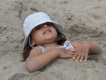 Ella Van Veen relaxing in the sand at Iroquois Beach Day on Friday August 12, 2022 in South Dundas, Ont. Shawna O'Neill/Cornwall Standard-Freeholder/Postmedia Network