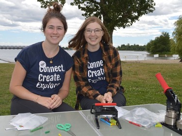 SDG Library employees Madisson Lamarche (left) and Chloe Whittaker helped attendees make buttons during the Iroquois Beach Day on Friday August 12, 2022 in South Dundas, Ont. Shawna O'Neill/Cornwall Standard-Freeholder/Postmedia Network