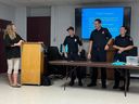 Jen Fullarton with Cornwall firefighters volunteering at the front of the conference room during one of her autism awareness presentations this week. Photo in Cornwall, Ont. Todd Hambleton/Cornwall Standard-Freeholder/Postmedia Network