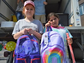 Callie Theoret (left) with friend Torrie Depatie showed off their new school supplies from Cornwall Agapè Centre's Back to School Giveaway on Thursday August 25, 2022 in Cornwall, Ont. Shawna O'Neill/Cornwall Standard-Freeholder/Postmedia Network