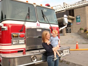 Linzi Leclerc with her son, Jasper Powell, in front of a Cornwall Fire Services fire truck at August's Touch-a-Truck event on Thursday August 25, 2022 in Cornwall, Ont. Laura Dalton/Cornwall Standard-Freeholder/Postmedia Network