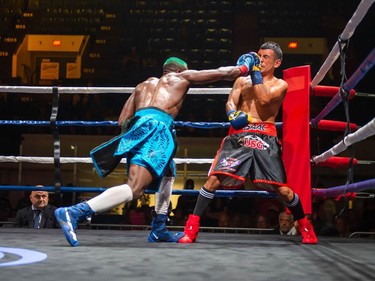 Montreal's Mohamed Soumaoro, left, swings at Isaac Casten on Monday August 8, 2022 in Cornwall, Ont. Soumaoro won in a unanimous decision after six rounds. Robert Lefebvre/Special to the Cornwall Standard-Freeholder/Postmedia Network