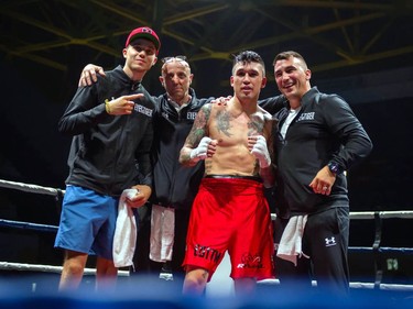 Calgary's Steve Claggett celebrates his win against Cornwall's Tony Luis with his support staff on Monday August 8, 2022 in Cornwall, Ont. Luis conceded the fight at the start of the seventh round. Robert Lefebvre/Special to the Cornwall Standard-Freeholder/Postmedia Network