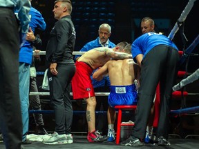 Calgary's Steve Claggett (red shorts), shares a few words with Cornwall's Tony Luis on Monday August 8, 2022 in Cornwall, Ont. Luis conceded the fight at the start of the seventh round. Robert Lefebvre/Special to the Cornwall Standard-Freeholder/Postmedia Network