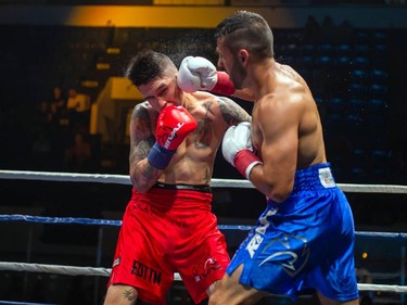 Cornwall's Tony Luis, right, connects with Calgary's Steve Claggett on Monday August 8, 2022 in Cornwall, Ont. Luis conceded the fight at the start of the seventh round. Robert Lefebvre/Special to the Cornwall Standard-Freeholder/Postmedia Network