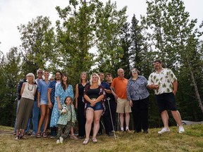 Members of the Bragg family pose in front of the bur oak in Bragg Creek on Saturday, Aug. 20, 2022. A bur oak tree was planted near park place and white ave in honour of the Bragg family.
