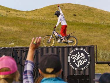 A motorcycle rider celebrates after performing a stunt at the Cochrane fair on Friday, Aug. 19, 2022.