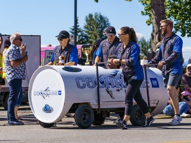 The Cochrane GM team takes a victory lap at the outhouse races in Cochrane on Sunday, Aug. 28, 2022.