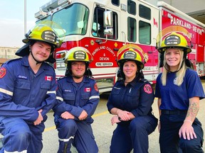 (L-R) Firefighters Josh De Graaf, Zac Bartel, Natasha Hancharuk and Averi Klak pose in front of a Parkland County & Devon Fire Services truck. (Supplied)