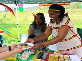 Rehoboth Alliance on Saturday, August 13, 2022 by J.J.  Ethiopian food is served to people at the Afro-Canadian Arts and Culture Festival held at Howard Pew Park.  Vincent McDermott/Fort McMurray Today/Postmedia Network