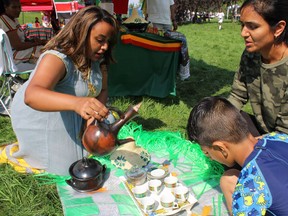 Hilina Tadesi on Saturday, August 13, 2022 by Rehoboth Alliance J.J.  Howard serves coffee from Ethiopia at the Afro-Canadian Arts and Culture Festival held in Pew Park.  Vincent McDermott/Fort McMurray Today/Postmedia Network