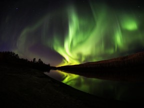 The Northern Lights shine and reflect on the Clearwater River in Fort McMurray Alta. on Wednesday September 28, 2016. Robert Murray/Fort McMurray Today/Postmedia Network