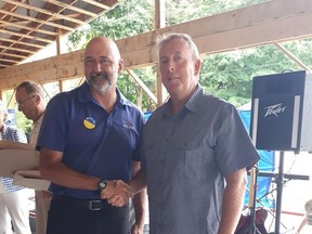 Bruce-Grey-Owen Sound MP Alex Ruff, left, congratulates Hanover Legion president Dan Haverson after being rewarded with a Platinum Jubilee Coin, one of two Hanover Legion members to receive the honour along with Alan Fisher.