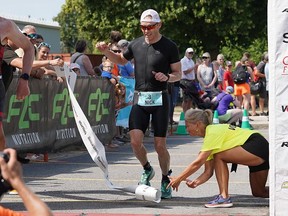 Nick Cosman of Kingston crosses the finish line in first place in the K-Town Triathlon's long-course race on Sunday, July 31, 2022. It was his first long-course victory in Kingston after past results included a second, third, fourth and fifth.
