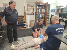 CPR student Grace Walton applies CPR to a mannequin while course instructors Garth Pigeau (standing) and Jeff Brubacher look on.  Brubacher and Pigeau are holding a CPR course at the Chisholm Fire Hall next month to instruct people on how to potentially save the life of anyone who suffers a cardiac arrest. Rocco Frangione/North Bay Nugget
