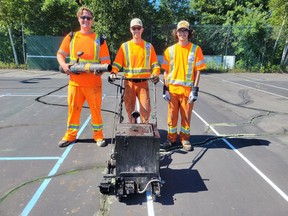From EverLine Coating and Services, Blaze Tattersall with the blower, Eric Giroux on the crack filler (forman) and Noah Van Bekkum have been on-hand to complete the project despite the heat. Jacqueline Rivet