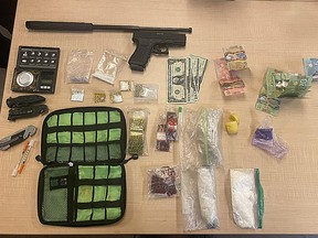 Kingston Police found a large quantity of suspected fentanyl, crystal methamphetamine, cocaine, multiple knives, a collapsible baton, an imitation firearm and Canadian and American currency in a vehicle they pulled over around 1 a.m. Sunday.