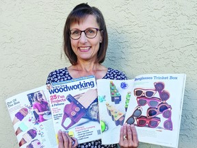 Woodworker Rita Cels poses with her four project designs featured in woodworking and crafts magazine, Scroll Saw. (Supplied)