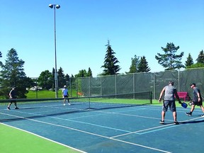 Members of the Leduc pickleball community play on the double-painted tennis and pickleball courts located by Leduc Composite High School. (Dianne Young)