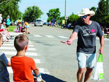 Foothills MP John Barlow throws a candy Monday, Aug. 1 during the Round-Up Days parade.