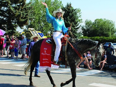 Calgary Stampede Princess Jenna Peters waves to the crowd during the Round-Up Days parade Monday, Aug. 1.