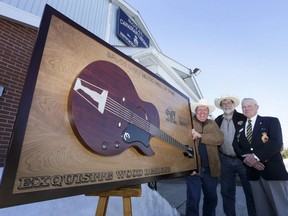 From left, Arnie Clark, Bill Murdoch and former Hepworth-Shallow Lake Royal Canadian Legion Branch 586 president Elmer Brown stand outside the legion with a large plaque for the Bruce Grey Music Hall of Fame in Hepworth, Ont. on Tuesday, March 24, 2015, before the hall was officially opened.