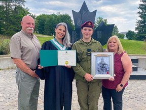 Marcie Lane, wearing her Algonquin College graduation gown, stands with her father, Harry Lane,  mother Bonnie Farrell, and her daughter Olivia Vernelli at the Soldier's Memorial at Garrison Petawawa. Submitted photo