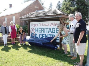 Unveiling the new Upper Ottawa Valley Heritage Centre name and sign at the former Champlain Trail Museum and Pioneer Village on Aug. 14 was, from left, Marianne Taylor, constituent assistant for MPP John Yakabuski, MP Cheryl Gallant, Julia Klimack, heritage centre manager, former Champlain Trail Museum curator Angela Siebarth, Ottawa Valley Historical Society president Steve Sipocz, and Laurentian Valley Councillor Chris Pleau. Anthony Dixon