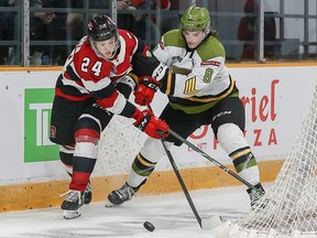 Ottawa 67's right wing Vinzenz Rohrer (24) and North Bay Battalion defenceman Avery Winslow (8) battle for the puck, April 25, 2022.  VALERIE WUTTI/OSEG
