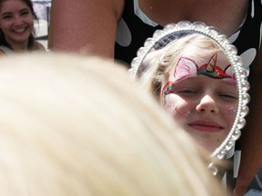 Rosemary Stoesser, six, checks out her face painted as a unicorn while at Art Crawl in downtown Sarnia Saturday.  The day was part of the second of three planned First Friday and Weekend Walkabout events this summer.  (Tyler Kula/ The Observer)