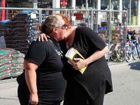 Laura Hodgins, right, hugs Petrolia Home Hardware co-owner Lana Mullins during a fundraiser the business helped run for her family on Friday.  Terry Bridge/Sarnia Observer/Postmedia Network
