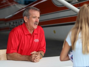 Retired astronaut Chris Hadfield talks to Lydia Martin, 12, from Sarnia during a fly-in event at the Sarnia Chris Hadfield Airport on Saturday.  Terry Bridge/Sarnia Observer/Postmedia Network