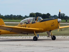 A pilot waves at the crowd during a fly-in event at the Sarnia Chris Hadfield Airport on Saturday.  Terry Bridge/Sarnia Observer/Postmedia Network