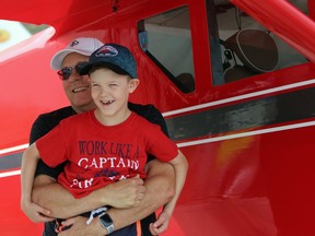 Grant Beasley, 8, from Sarnia laughs as he's hugged by grandpa Dave during a fly-in event at the Sarnia Chris Hadfield Airport on Saturday.  Terry Bridge/Sarnia Observer/Postmedia Network