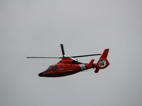 A US Coast Guard helicopter flies Sunday over the St. Clair River Float Down.