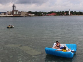 Participants in the St. Clair River Float Down Sunday head for the river after leaving the shore of Lake Huron in Sarnia.