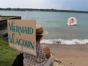 Alexsandra Johnston of Windsor sits on an inflatable clamshell in the St. Clair River at Mermaid Lagoon during the Mermaids and Mariners festival Saturday held at Brander Park in Port Lambton.