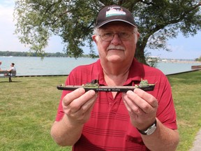 Don Lee holds a finished wooden lake freighter model while standing near the St. Clair River. He was selling model kits Saturday at a Mermaids and Mariners festival at Port Lambton’s Brander Park. The kits were in support of the Sombra Museum.