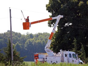 Ontario Hydro crews work near a crash at the intersection of Inwood Road and Courtright Line in Brooke-Alvinston Tuesday.  (Terry Bridge/Sarnia Observer)