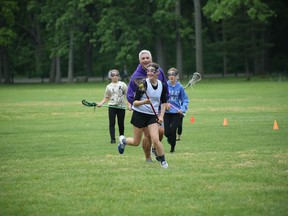 Brian DeWagner is pictured with girls in the Janie Lax program.  (Photo via June Partridge)