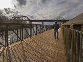 A man walks across the East Gap bridge shortly after it was installed as part of the Waterford trail system last November.