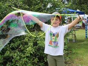 Seven-year-old Walter Dowling of Simcoe has fun with bubbles on Sunday, July 31 in the KidZone at the Simcoe Heritage Friendship Festival.